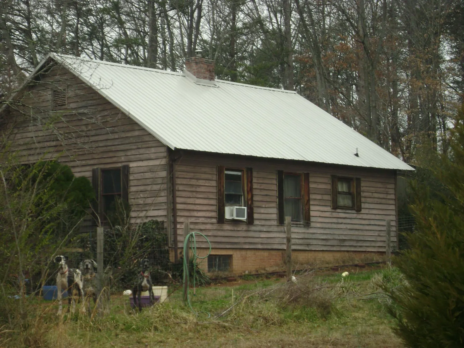White metal roof on an old wood sided farmhouse, from a Metal Roof Installation job in Scottville