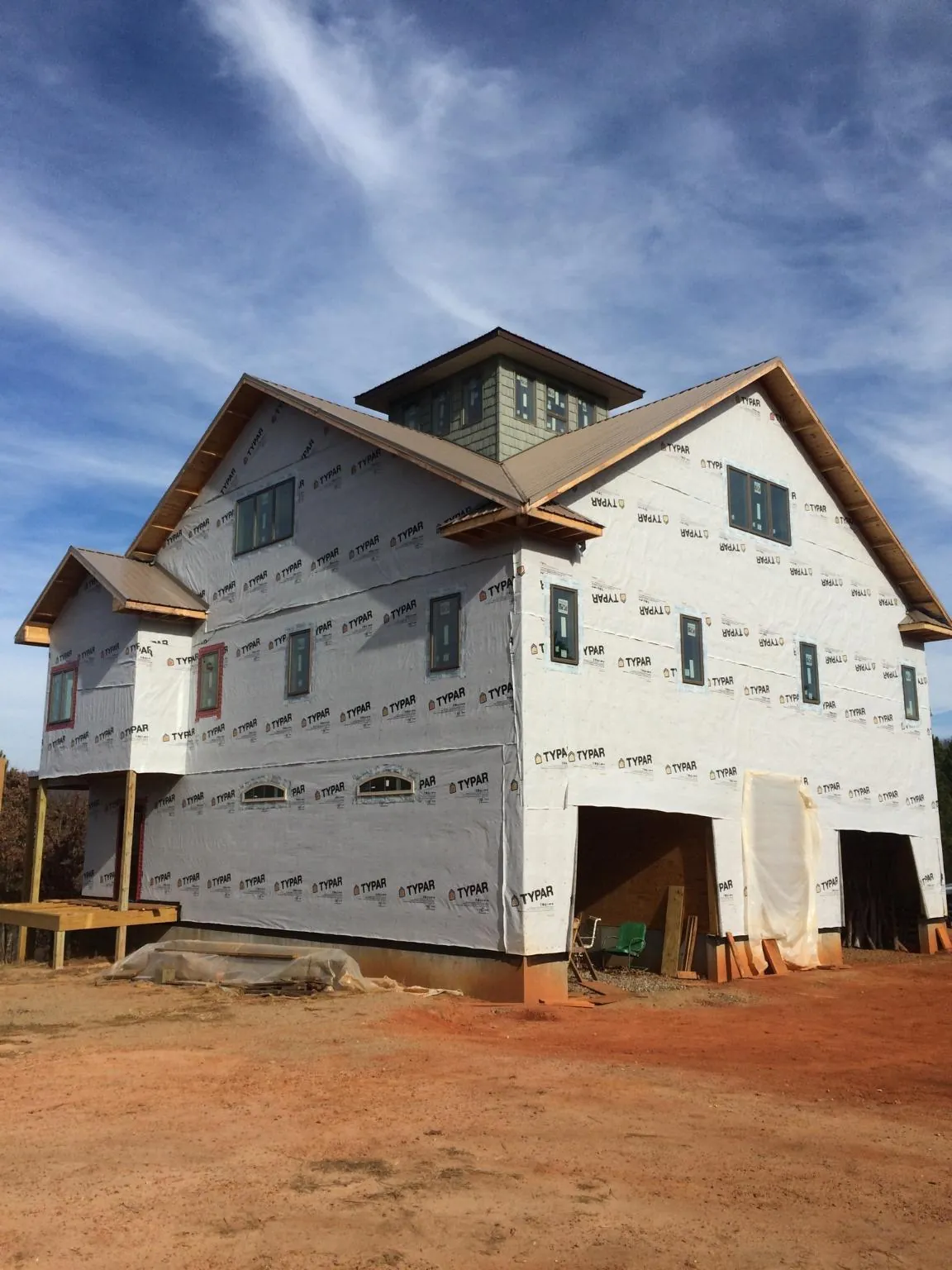 New two story house under construction with a cupola and gabled roofs in Scottville